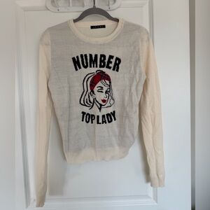 Cream Sweater with Graphic Design and Red Accents